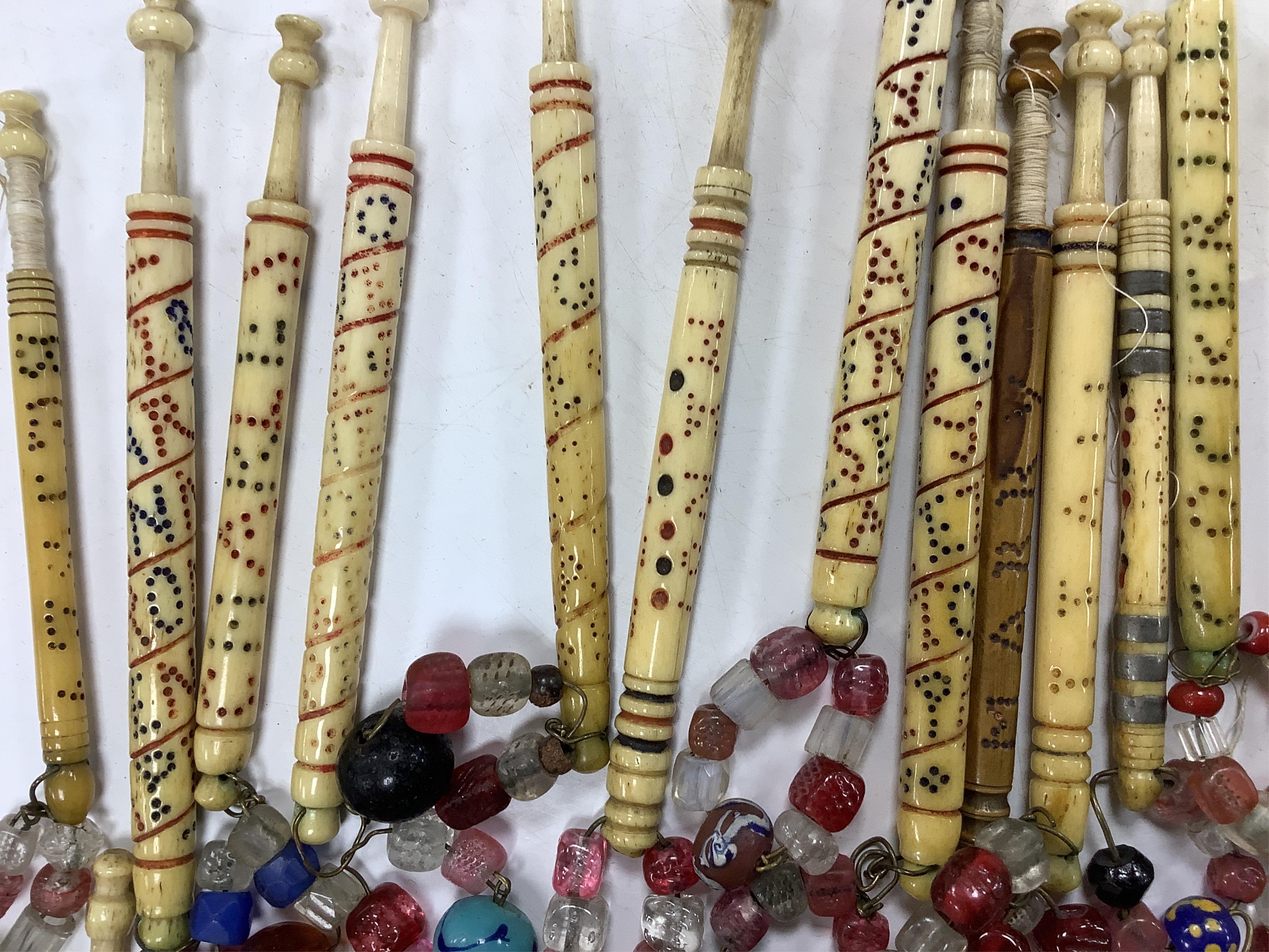 A collection of 19th century named and motto bone lace bobbins, including three named Barry bobbins with a related EB red embroidered monogram to lace edged hankie.(31 bobbins) Condition- light rust staining to hankie, b